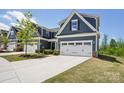 Charming home with a two-car garage, manicured lawn and beautiful landscaping at 6295 Ashton Park Dr, Denver, NC 28037