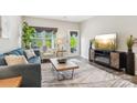 Living room with neutral walls and decor, a comfortable sofa and a large window at 6295 Ashton Park Dr, Denver, NC 28037