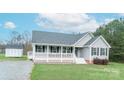 Charming home with a covered front porch, a storage shed on a spacious yard at 6300 Bill Sain Rd, Vale, NC 28168