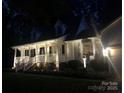 Well-lit home at night with a cozy front porch and manicured landscaping at 709 Weldon Ln, Salisbury, NC 28146