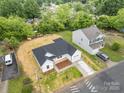 A high-angle view showcases a white, single-story home and its surrounding neighborhood at 722 English St, Monroe, NC 28110