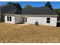 View of the home's backyard, featuring a cozy patio and ample green space at 722 English St, Monroe, NC 28110