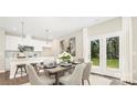 Bright dining area with french doors and kitchen view at 722 English St, Monroe, NC 28110