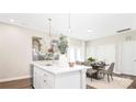 Open-concept kitchen with a center island, modern lighting, and a dining area at 722 English St, Monroe, NC 28110