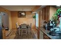 The dining room features a dining table with seating, with kitchen features to the side at 8524 Stoneman Pl, Charlotte, NC 28217