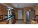 The kitchen features granite counters, tile backsplash, stainless steel fridge and tile flooring at 8524 Stoneman Pl, Charlotte, NC 28217