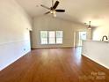 Bright living room featuring wood floors, vaulted ceilings, and natural light through large windows at 8551 Appledale Dr, Charlotte, NC 28262