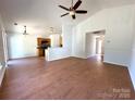 Open-concept living space with hardwood floors, opening into the kitchen and hallway at 8551 Appledale Dr, Charlotte, NC 28262