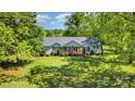 A bird's eye view of a one story home with beautiful surrounding trees and expansive green yard at 940 Hatchett Rd, Lincolnton, NC 28092