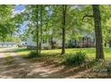 View of the house from a tree-lined drive way; includes a detached shed and space for a RV at 940 Hatchett Rd, Lincolnton, NC 28092