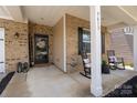 Welcoming front porch featuring a decorative front door, rocking chairs, and a 'Welcome' sign at 9613 Fire Bellied Ct, Lancaster, SC 29720