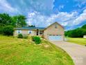 Well-maintained brick house with a front lawn and beautiful landscaping under a partly cloudy sky at 970 Mt Moriah Church Rd, China Grove, NC 28023