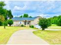 A well-maintained brick home with a large front yard, driveway, and some landscaping at 970 Mt Moriah Church Rd, China Grove, NC 28023