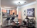 The dining area features modern lighting fixtures, complementing the adjacent kitchen and living spaces at 9832 Longstone Ln, Charlotte, NC 28277