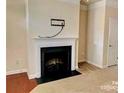 Cozy living room featuring a classic fireplace with a decorative mantle at 9832 Longstone Ln, Charlotte, NC 28277