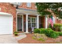 Inviting front porch with rocking chairs and a 'Welcome' sign, framed by manicured landscaping at 11329 Corliss Ave, Charlotte, NC 28277