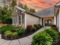 Beautiful home exterior with stone accents, complemented by a well-maintained lawn and vibrant landscaping at 11727 Dunham Dr, Matthews, NC 28105