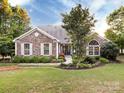 Attractive single-Gathering home with stone detailing, bright windows, and a neatly landscaped front yard at 11727 Dunham Dr, Matthews, NC 28105