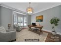 This office features an area rug, a modern light fixture, and a beautiful bay window for natural light at 128 Spears Creek Dr, Mooresville, NC 28117