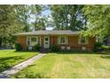 Charming brick ranch home with a neatly landscaped front yard and sidewalk at 1301 Burnwick Ct, Charlotte, NC 28213