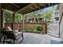 Inviting patio with brick fencing, lush garden, and comfortable seating area for outdoor enjoyment at 1608 Sharon W Rd # 55, Charlotte, NC 28210
