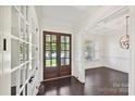 Spacious foyer with hardwood floors, white trim, and a view of the yard through glass paneled double doors at 1614 Tarrington Way, Indian Trail, NC 28079