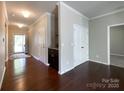 A bright entryway with hardwood floors features a storage closet and a bar with granite countertop at 1876 Yellow Daisy Dr, Matthews, NC 28104