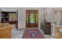 Elegant foyer features marble flooring, detailed woodwork, and a glimpse of the outdoor scenery at 19501 River Falls Dr, Davidson, NC 28036