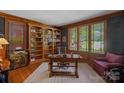 Well-appointed home office with custom built-in bookshelves and natural light at 19501 River Falls Dr, Davidson, NC 28036