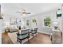 Bright living room with hardwood floors, neutral decor, and large windows showcasing natural light at 2008 Highland St, Charlotte, NC 28208