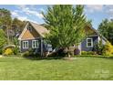 Charming home featuring a lush green lawn and well-maintained landscaping and traditional American architecture at 219 Reese Wilson Rd, Belmont, NC 28012