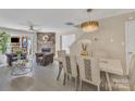 Inviting living room with stone fireplace, ample seating, and elegant dining area at 3127 Ocalle Ln, Indian Land, SC 29707
