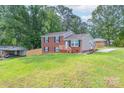 A charming brick home with a well-maintained lawn and a wooden fence at 3219 Spring Valley Dr, Gastonia, NC 28052