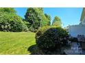 Expansive backyard with well-maintained lawn and patio area, ideal for outdoor activities at 3412 Summerfield Ridge Ln, Matthews, NC 28105