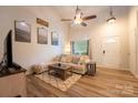 Cozy living room with wood floors, vaulted ceilings, and ample natural light at 3412 Summerfield Ridge Ln, Matthews, NC 28105