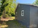 A side view of a single-story home surrounded by lush greenery at 358 Orr Dr, Rock Hill, SC 29730