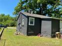 Side of a single story home with green grass yard and brick chimney at 358 Orr Dr, Rock Hill, SC 29730