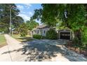 Traditional-style home with detached garage and long driveway, with mature trees at 3612 The Plz, Charlotte, NC 28205