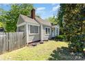 Quaint home featuring a charming fenced yard and lovely flower beds at 3612 The Plz, Charlotte, NC 28205