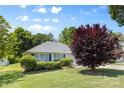Single story house with manicured front yard, lush trees, and tasteful landscaping at 3744 Leela Palace Way, Fort Mill, SC 29708