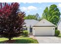 Inviting single-story home with a well-maintained lawn, mature tree, and attached two car garage at 3744 Leela Palace Way, Fort Mill, SC 29708