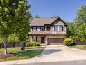 Beautiful two-story home with a brick and siding exterior, complemented by a lush front yard and trees at 4012 Martele Dr, Mint Hill, NC 28227