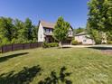 Expansive lawn with mature trees surrounding this two-story home, creating a serene outdoor space at 4012 Martele Dr, Mint Hill, NC 28227