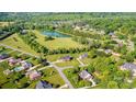 Expansive aerial view showcasing the community's pond, lush greenery, and single Gathering homes at 4047 Rainbow Hills Dr, Hickory, NC 28602