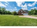 Beautiful home with a spacious yard, featuring a convenient two-car garage and a classic brick exterior at 4047 Rainbow Hills Dr, Hickory, NC 28602
