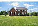 Charming two-story brick home with black shutters and verdant lawn, exuding classic elegance and curb appeal at 4047 Rainbow Hills Dr, Hickory, NC 28602