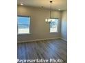 Elegant dining area with wood-look floors, recessed lighting, and natural light from windows at 6209 Busch Way, Midland, NC 28107
