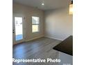 Bright kitchenette featuring wood-look floors, and a door leading to the exterior of the home at 6209 Busch Way, Midland, NC 28107