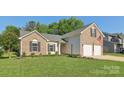 Charming brick and vinyl home with well maintained lawn at 6724 Long Nook Ln, Indian Trail, NC 28079