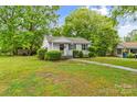Inviting one-story home with a covered porch and lush green lawn, perfect for outdoor enjoyment at 93 34Th Street Nw Ct, Hickory, NC 28601